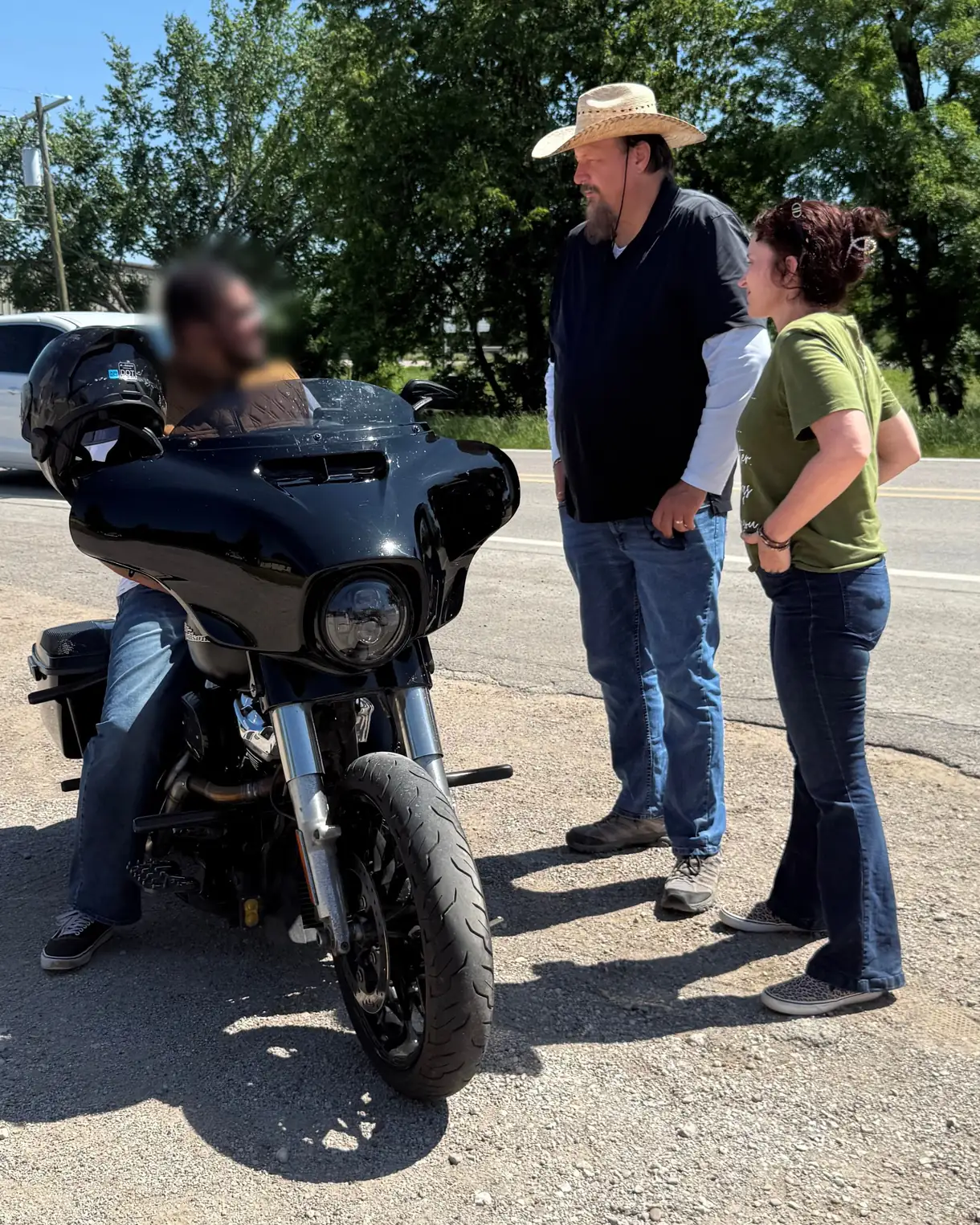 Two Seek the City outreach workers stopping on a Texas roadside to talk and pray with a motorcyclist.